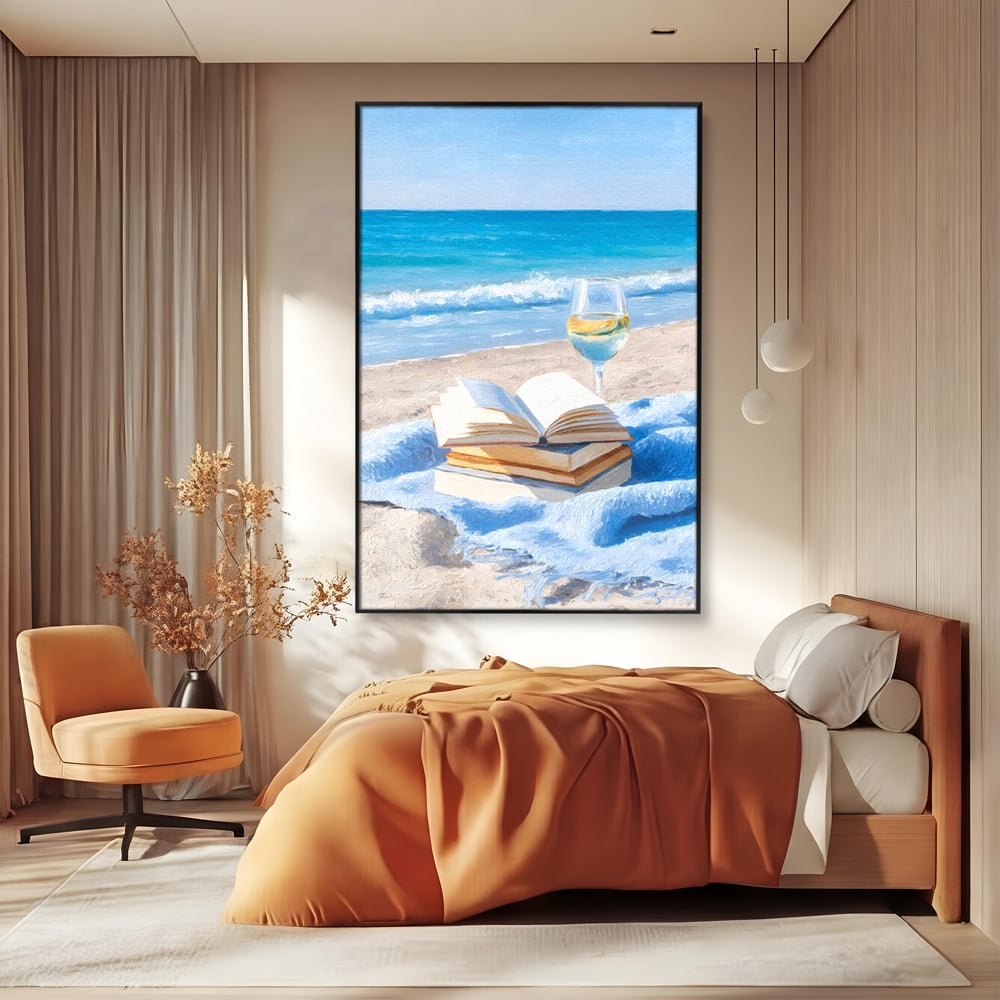 Tablou canvas cu pictura cu carti si pahar de vin pe plaja, in rama de aluminiu negru, pe perete intr-un dormitor
